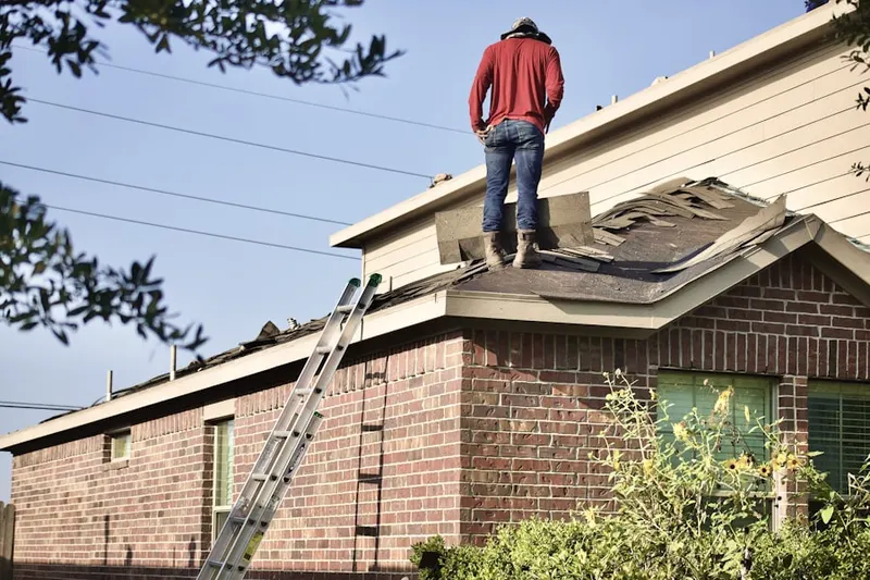Professional roofer working on a residential roof in Trapp